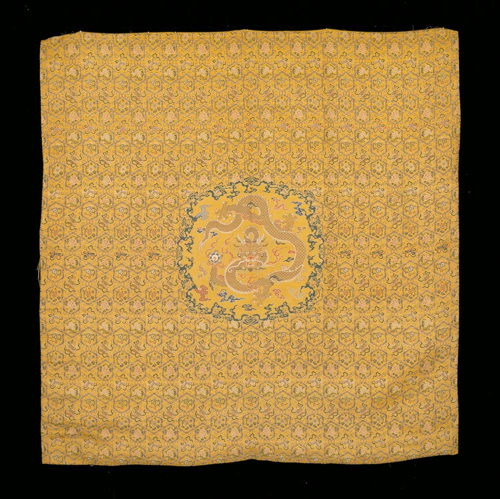 Throne cover of imperial yellow brocaded silk. Diaper ground six-petalled medallions and elongated hexagons in gold and…