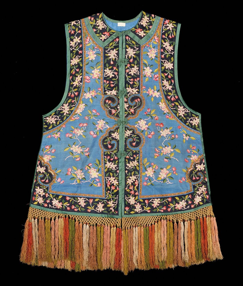 Sleeveless vest of medium blue kesi with sprays of plum blossom in red, pink, green, and purple. Border of black kesi with…