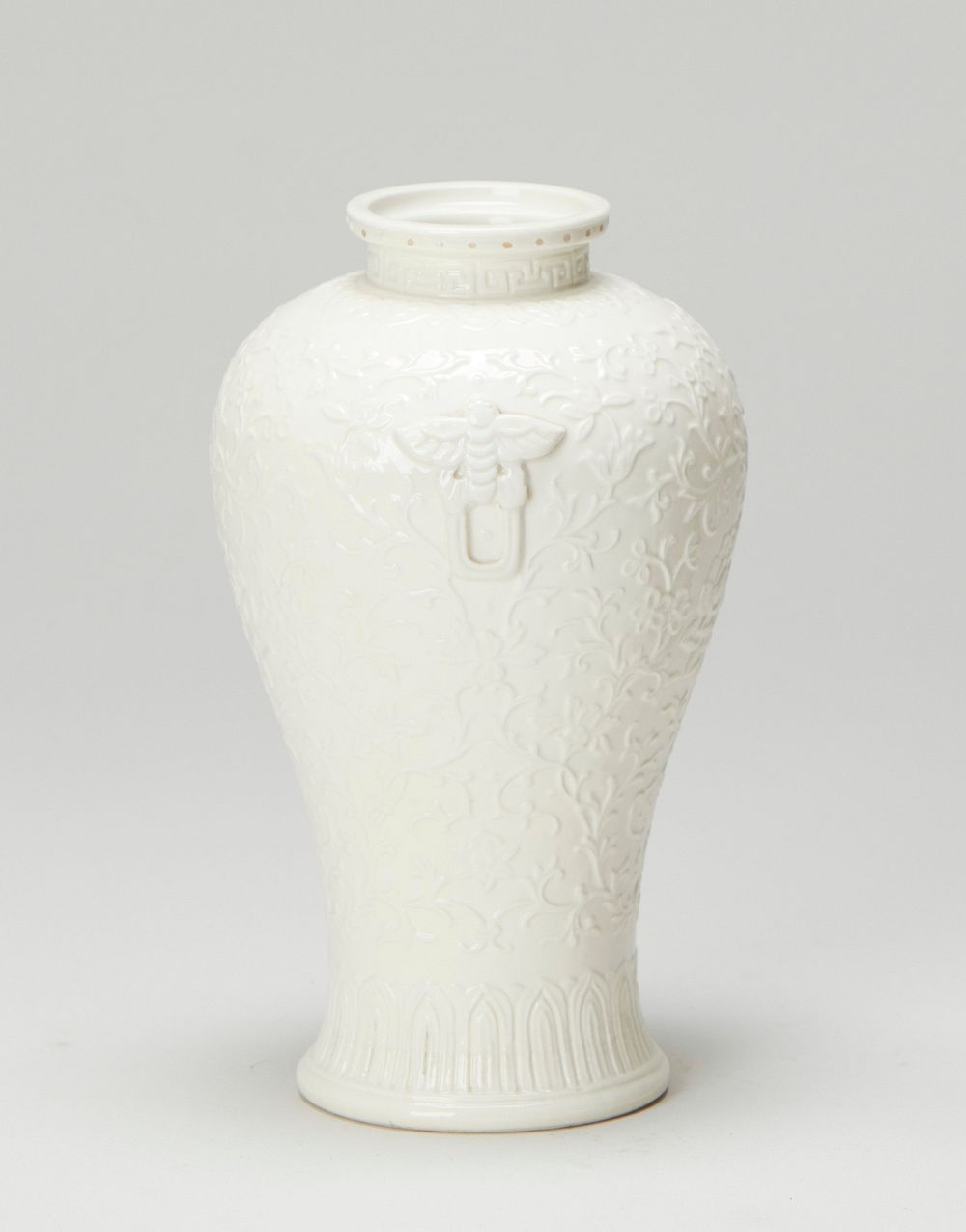 Small, white porcelain; delicate surface decoration of floral motif.. Original from the Minneapolis Institute of Art.