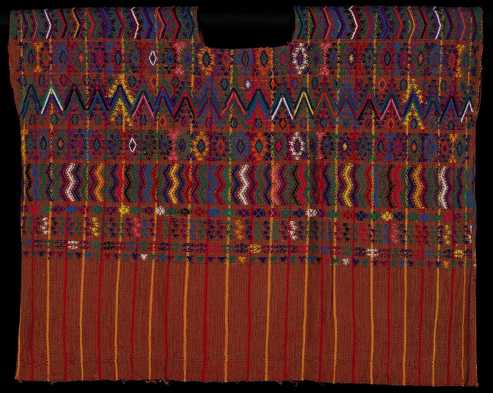 warp woven with brown, and red and yellow stripes; rounded neckline; multicolored brocaded designs of zigzags, flowers…