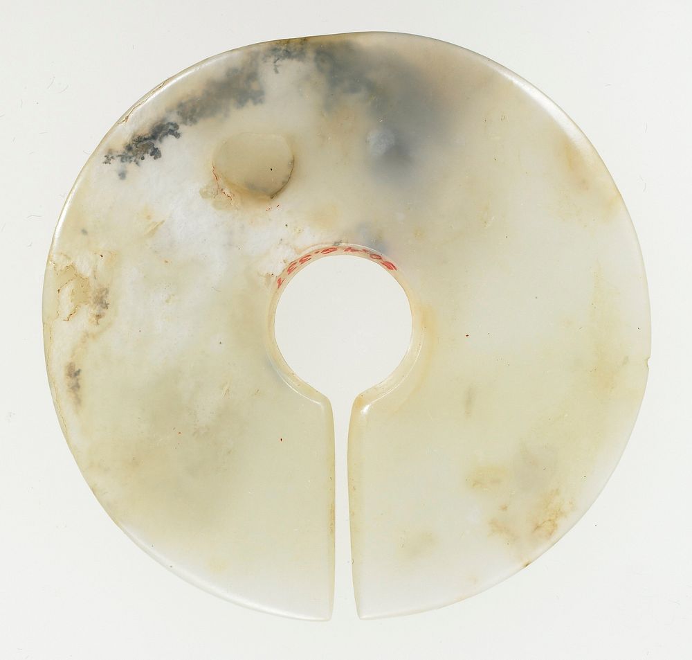 plain surface; translucent white jade with opaque white marks of calcification. The disk shaped object is often identified…