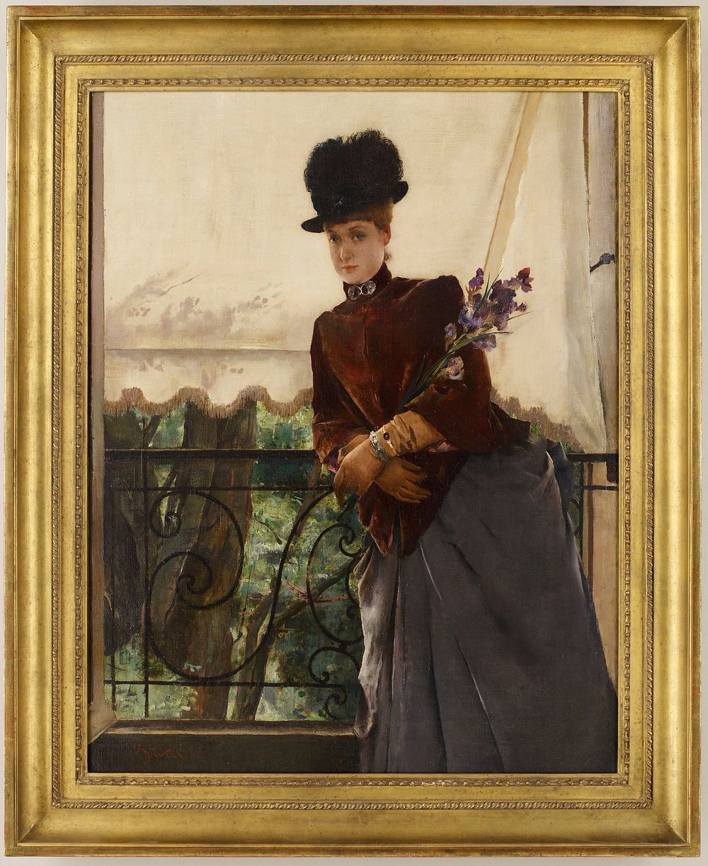 woman wearing a black hat, short maroon cape, long tan gloves and grey skirt, holding purple flowers and leaning on a black…