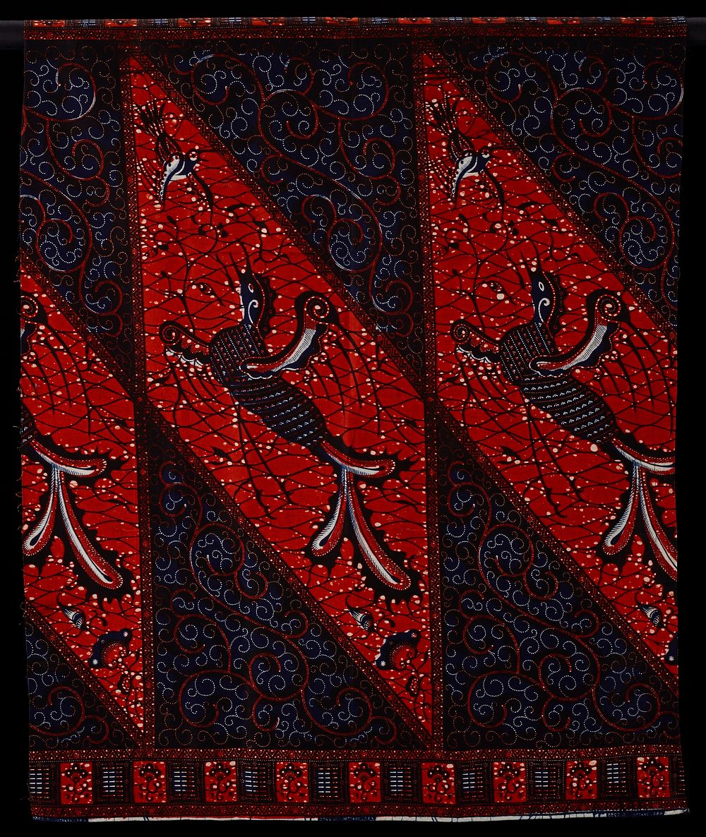 red/ orange diamond forms with blue birds; flower pattern along short ends. Original from the Minneapolis Institute of Art.