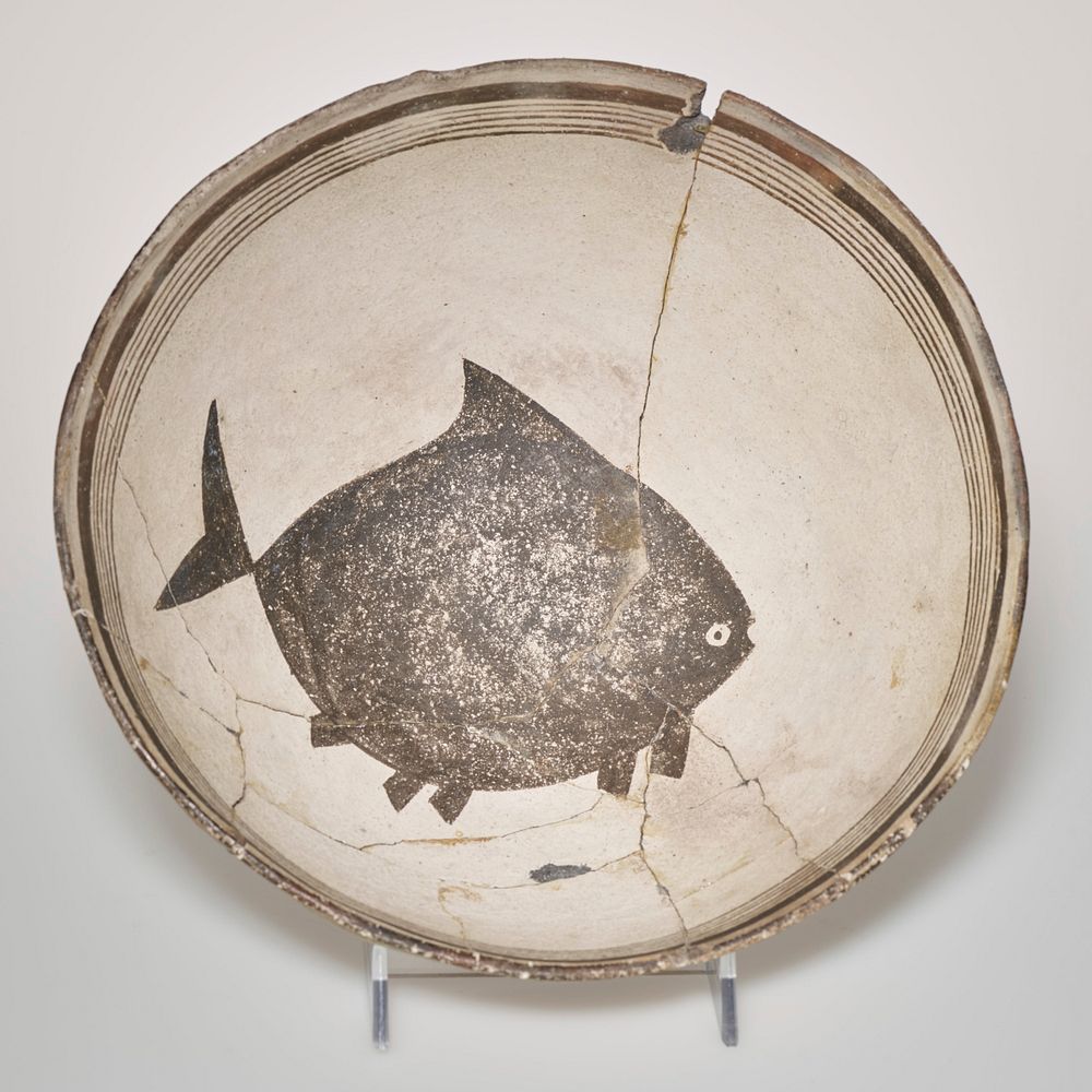 FJS #105; six concentric lines around upper inside of rim; large flounder-like fish at bottom inside of bowl. Original from…