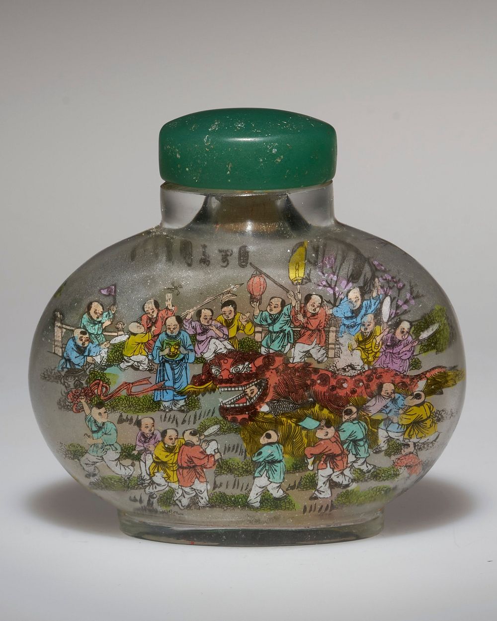 frosted clear glass with images on each side of children in brightly-colored garments, carrying lanterns and fans, playing…