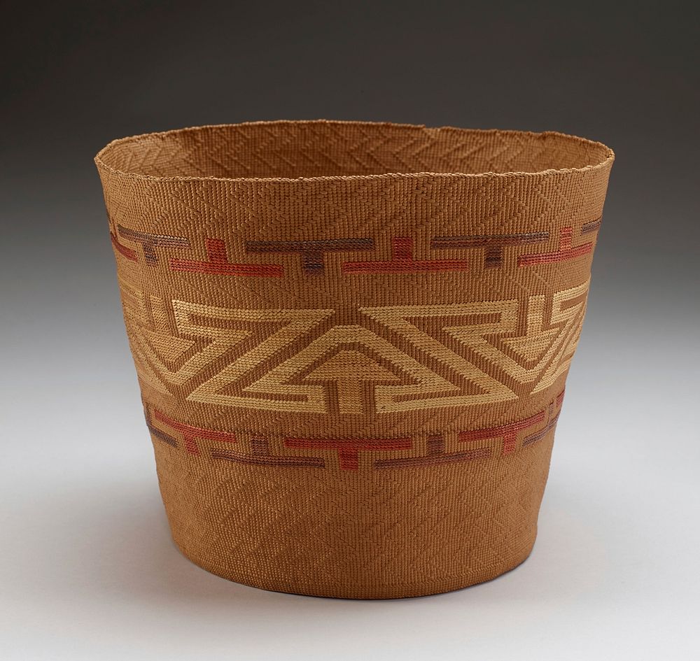 soft, flexible basket; concave bottom; slightly outward-flaring sides; tan; decorated with central band with repeating arrow…