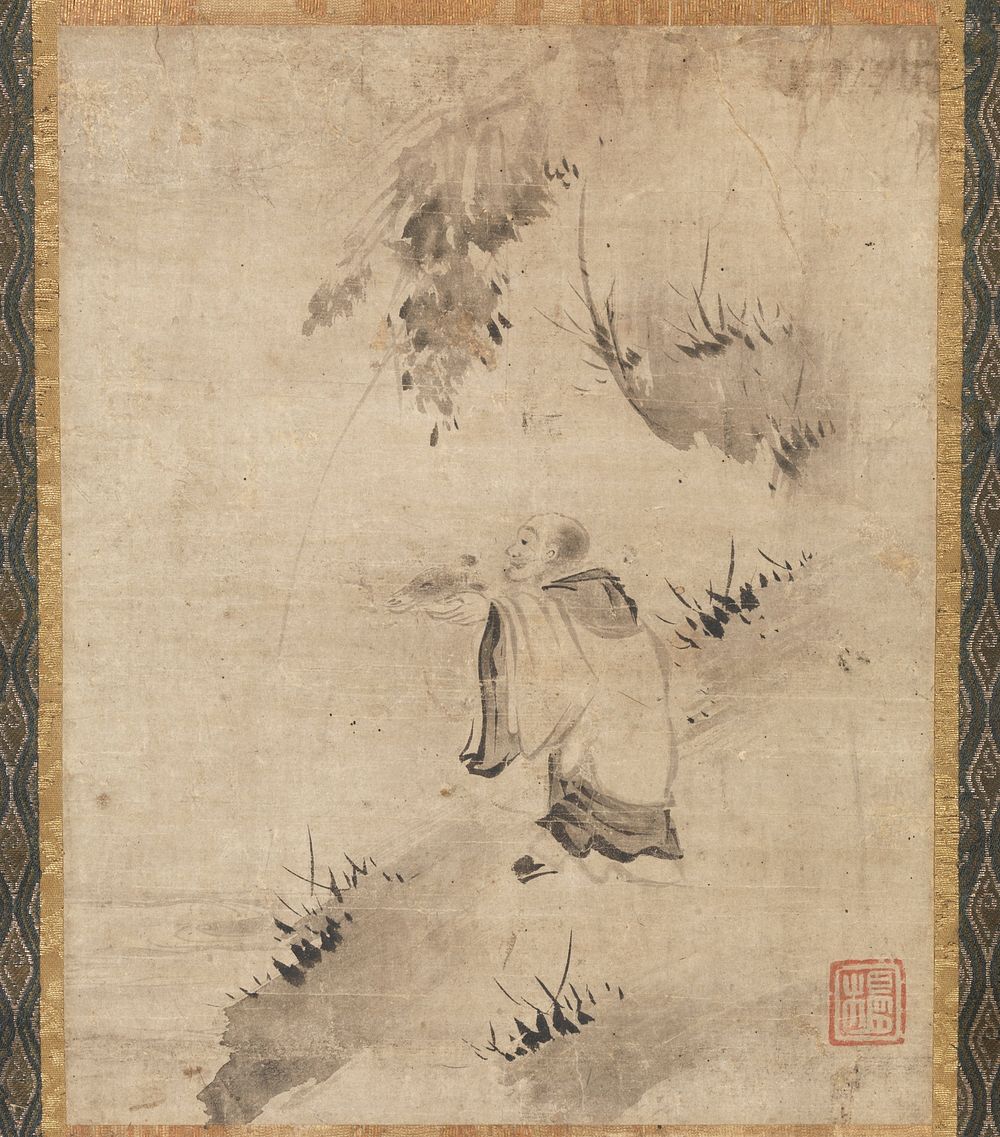 male figure in white monk's robes standing on sloping shoreline; figure holds out an animal head in his extended hands; rock…