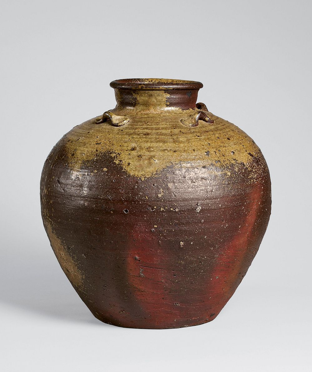 Jar with slightly raised neck, rolled lip; four bow-like loops on top of shoulder; dark brown coloring with large splashes…