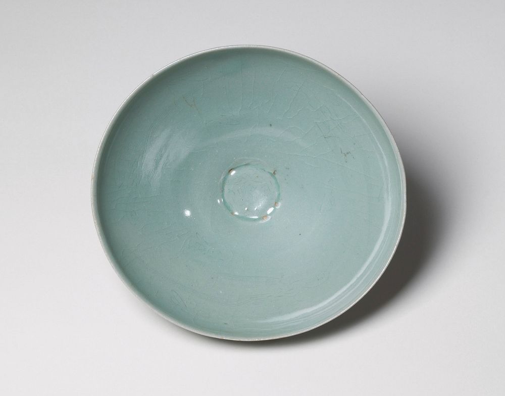 Bowl with shallow, thinly incised birds flying inside with long, trailing feathers; very narrow base and wide mouth; celadon…