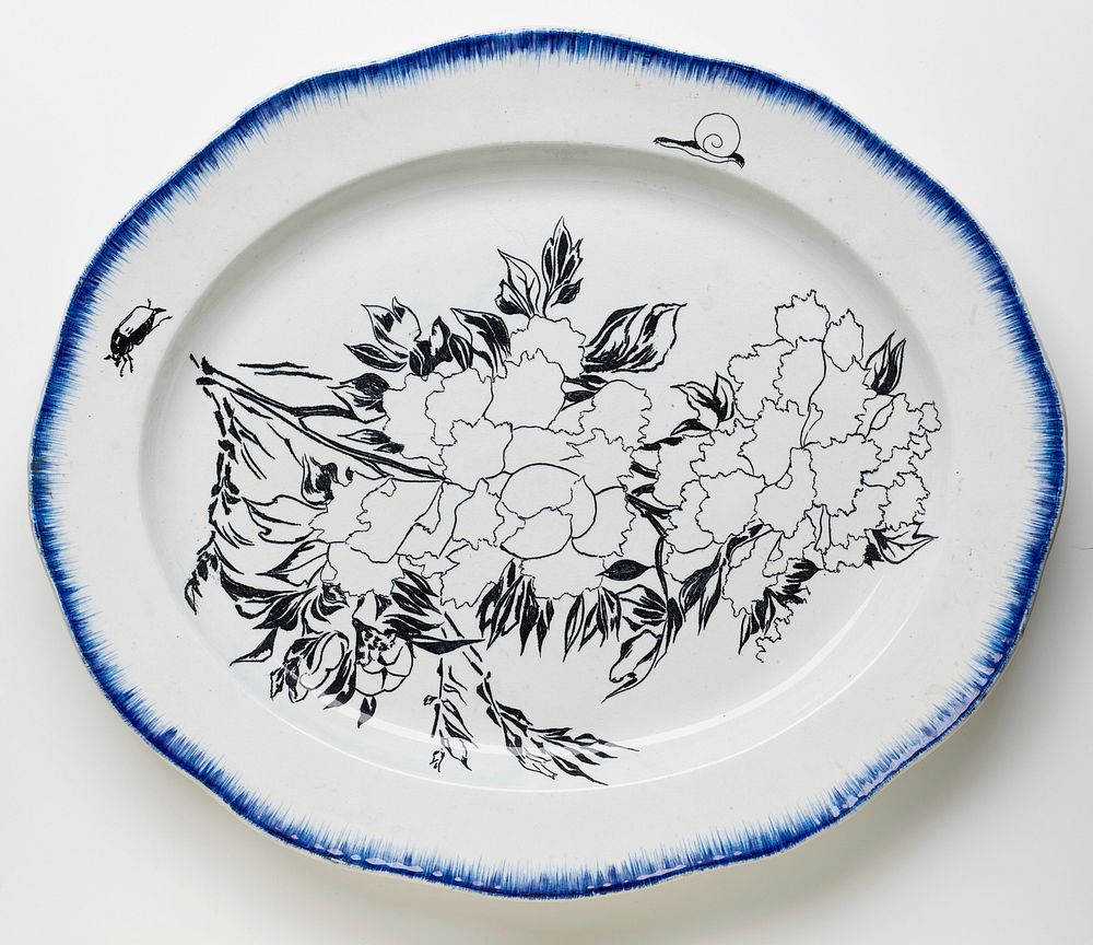 white oval platter with scalloped edge; brushed blue pigment around edge with peonies, a snail and a beetle painted in…