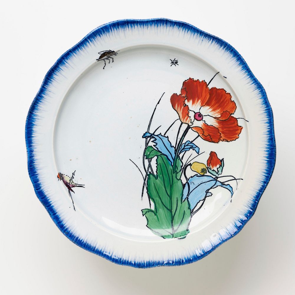 cake plate with white ground and brushed blue pigment around edge of plate and foot with painted flower, small bird, beetle…
