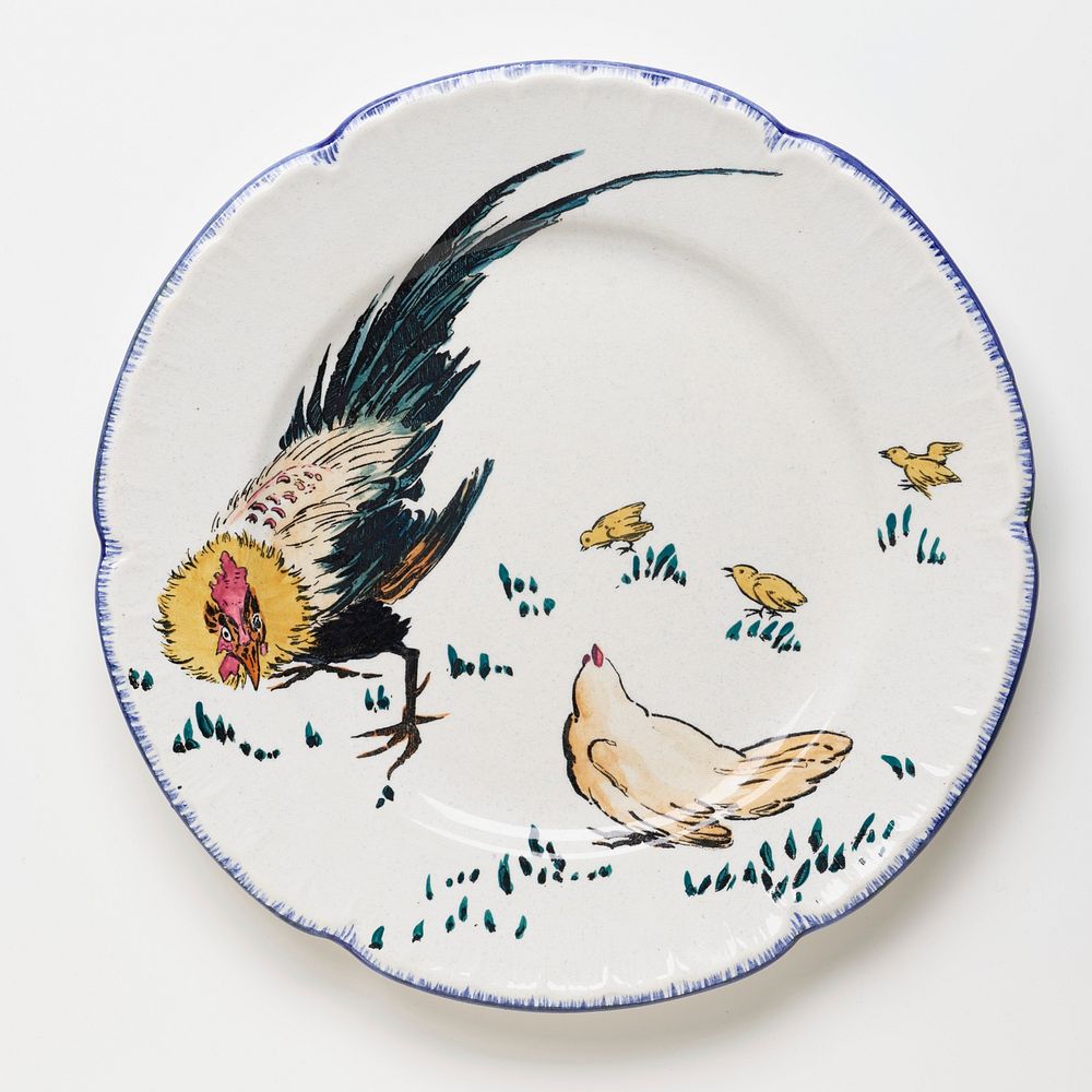Small dinner plate decorated with yellow, green, black, and tan rooster at left, tan hen at bottom center, and three yellow…