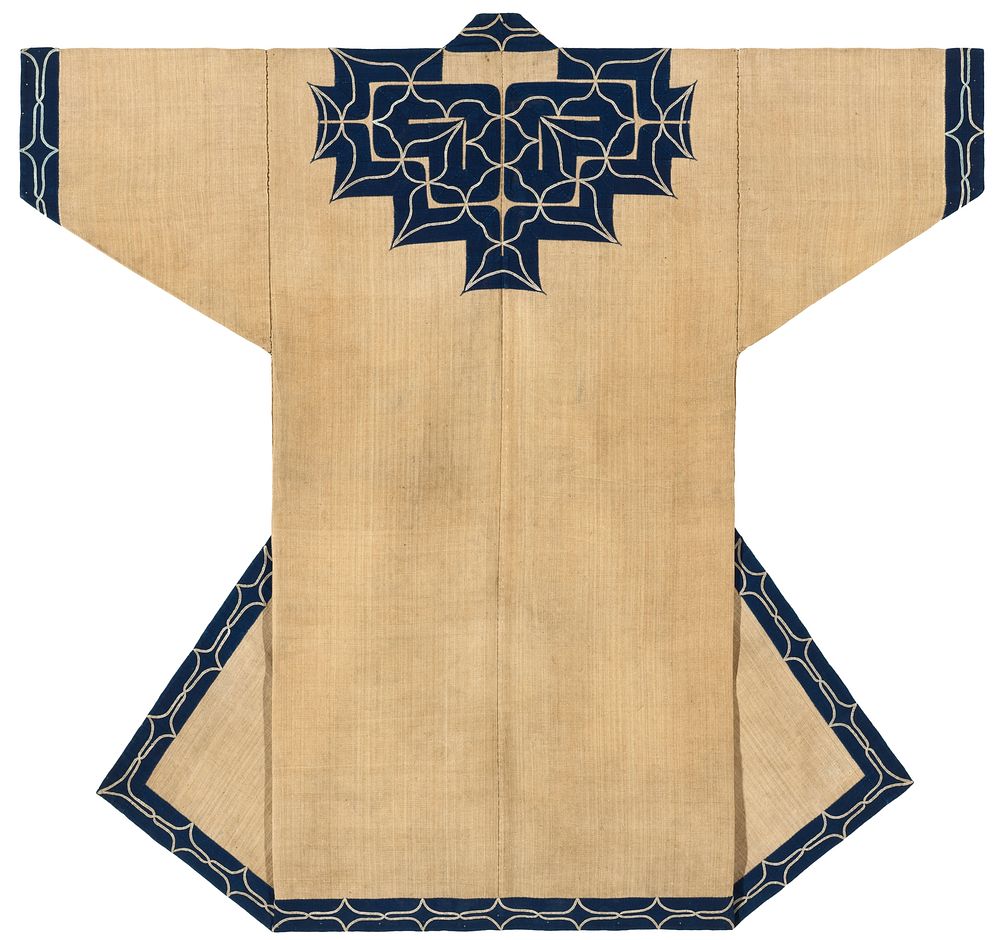 Tan robe covered with navy blue applique trim on sleeve cuffs, collar and yoke, center back, and along center edged and…