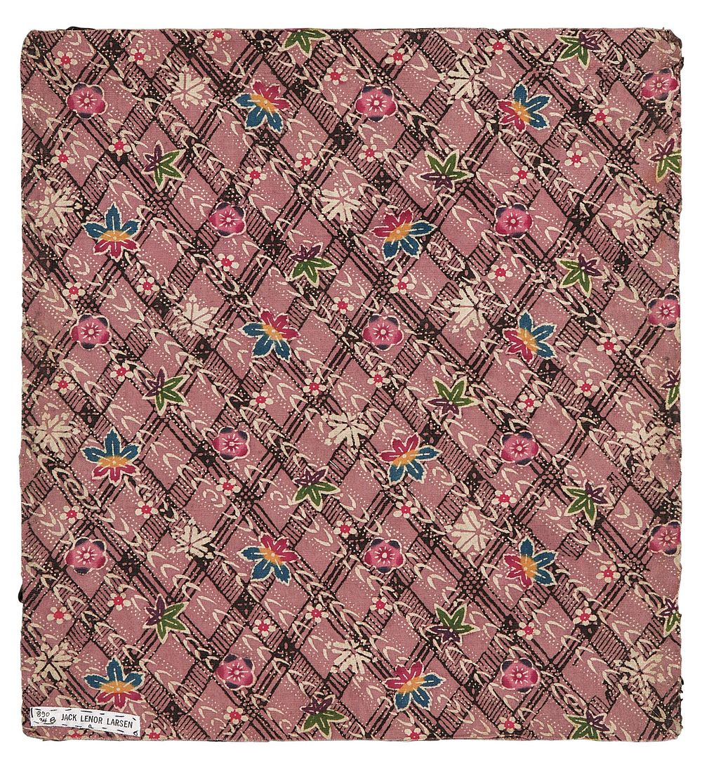 Rectangular fragment of pink fabric with black diamond lattice patter in background, with diagonal, white leaf pattern over…