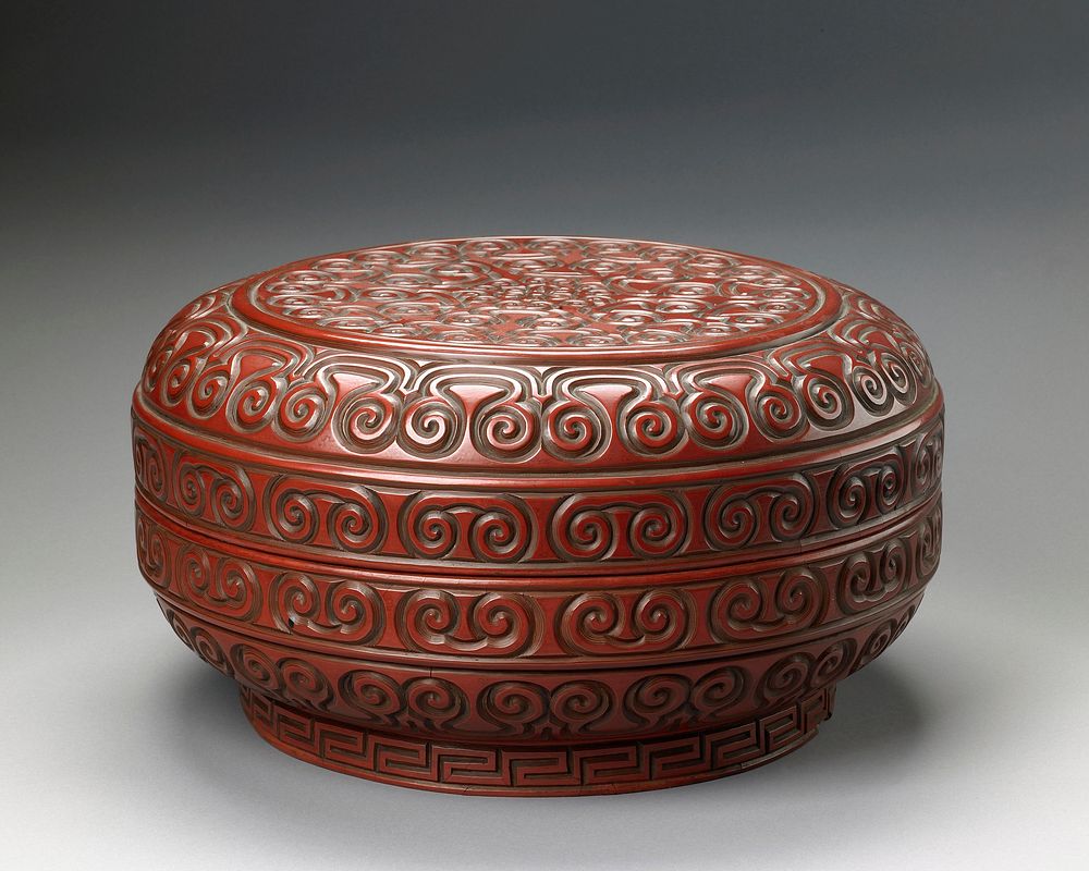 covered box, carved red lacquer in scroll design.. Original from the Minneapolis Institute of Art.