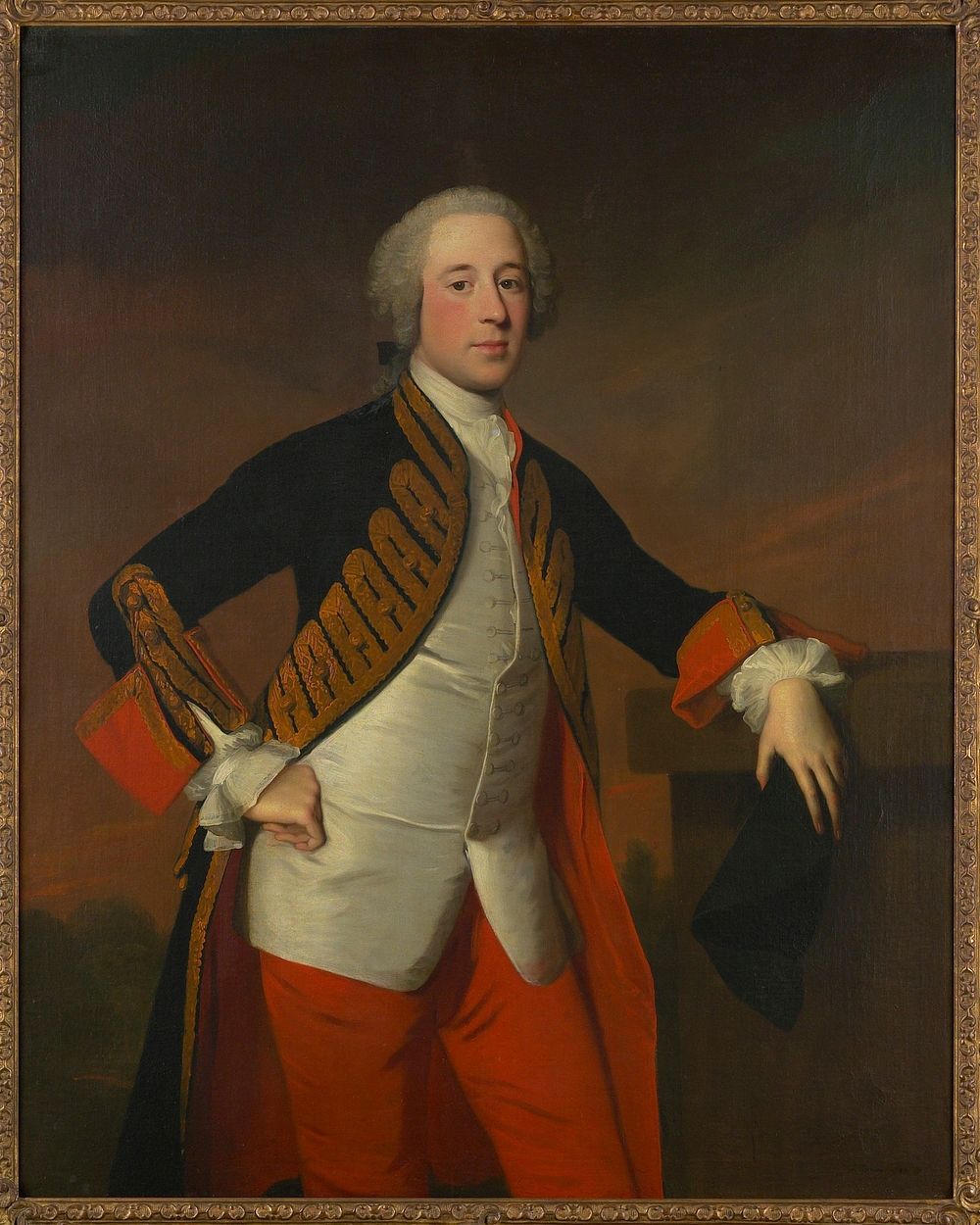 Portrait. Man dressed in red breeches and a blue velvet coat trimmed with gold braid and lined with crimson, is leaning with…