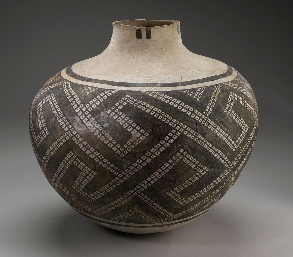 Tan vessel with a geometric design painted on with black pigment.. Original from the Minneapolis Institute of Art.
