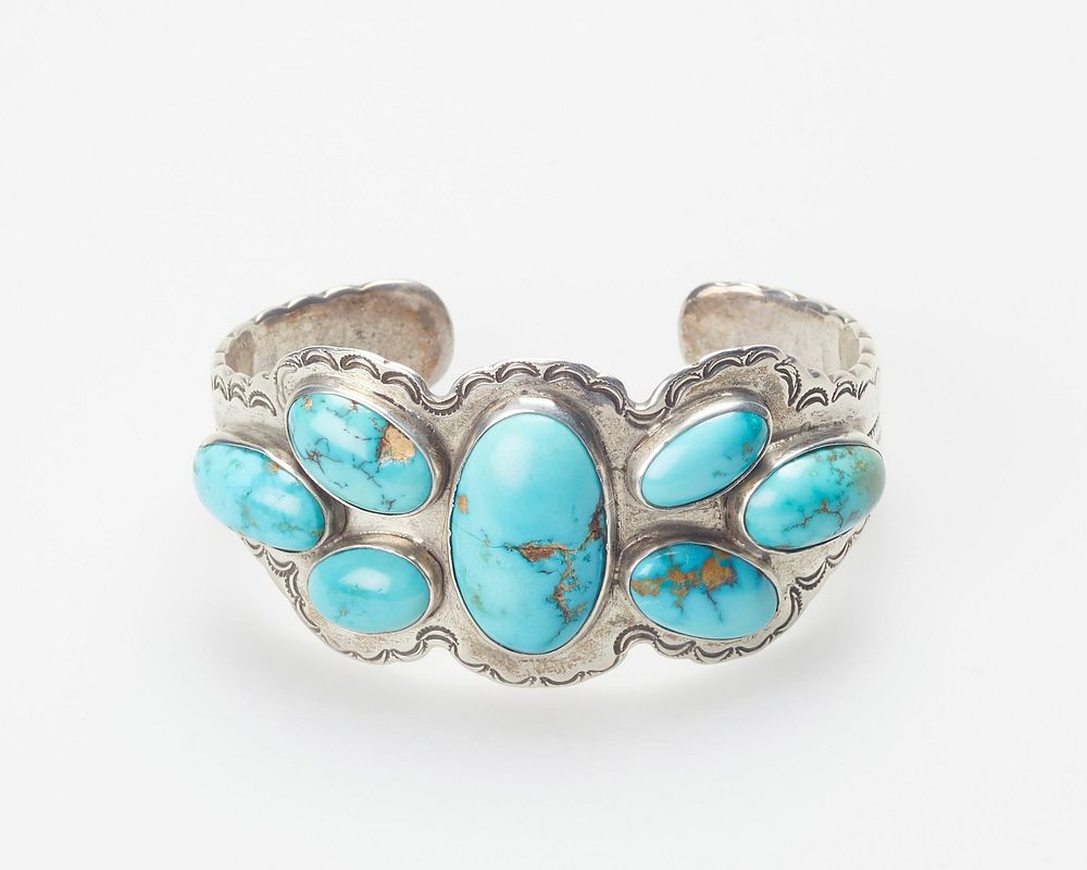 Scallop-edged annealed band; set with seven elliptical cabochon turquoises (possibly Stennich). Original from the…