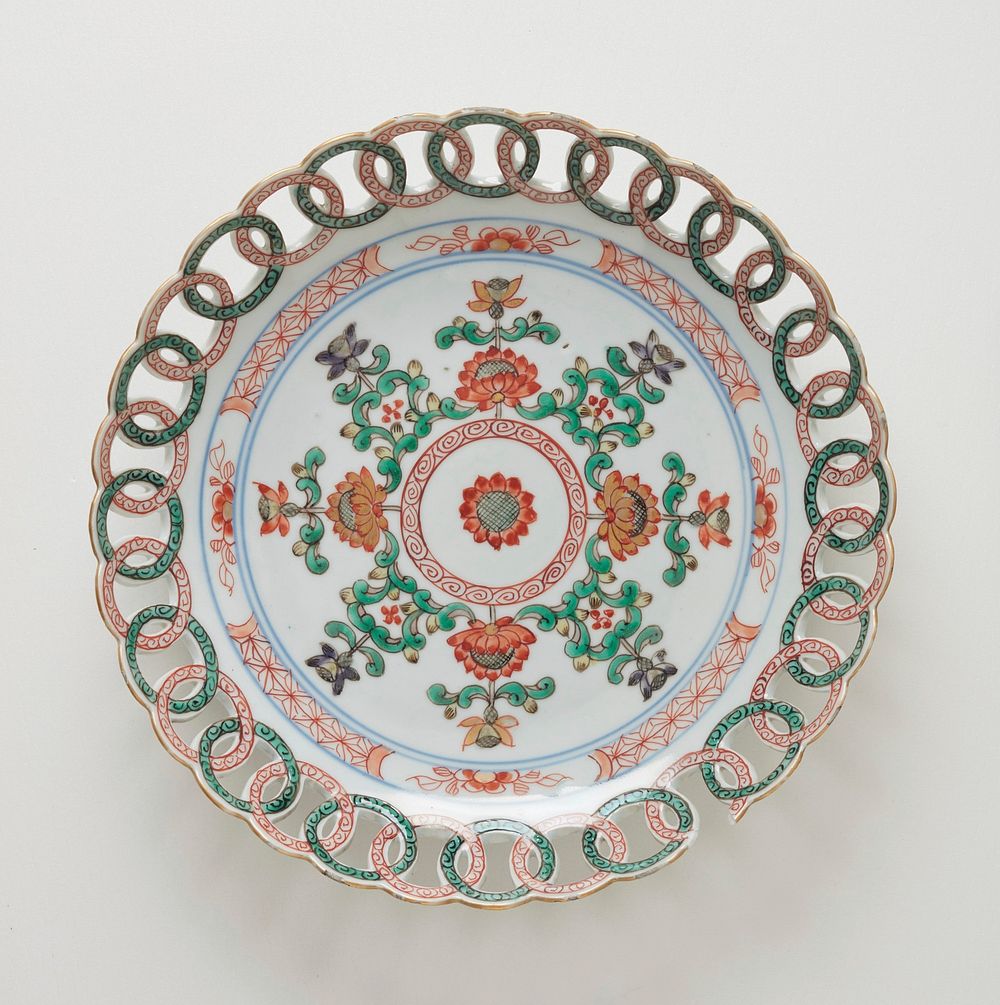 PIECE BROKEN ON TOP OF DISH; plate, green and red floral design with open work border of circles. Original from the…