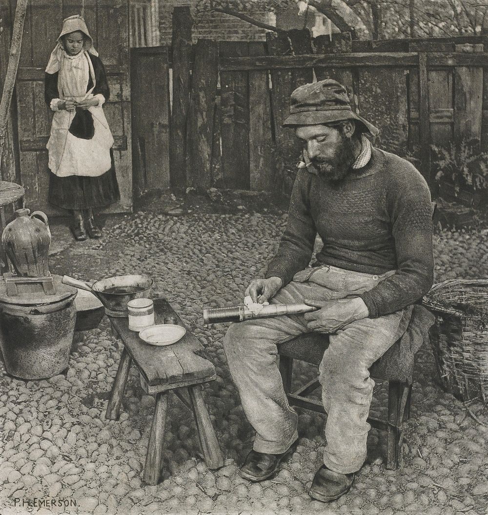 yard with seated man in foreground, wearing a hat, sweater and pants and smoking a pipe, wiping off a telescope in his lap;…