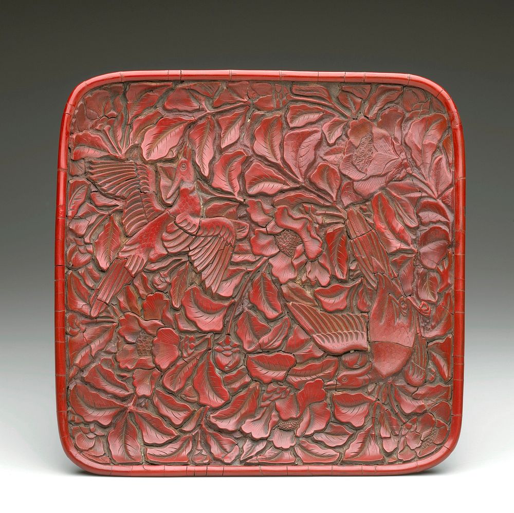 square with rounded corners; carved red lacquer with 2 birds in peonies; short foot with scrolls on exterior edge. Original…