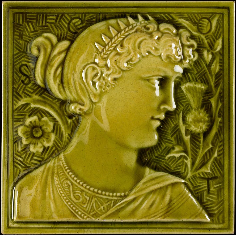 pea-green glaze over high relief carving of a woman's head in profile; flower on L, thistle on R; "SCOT", incorporated into…