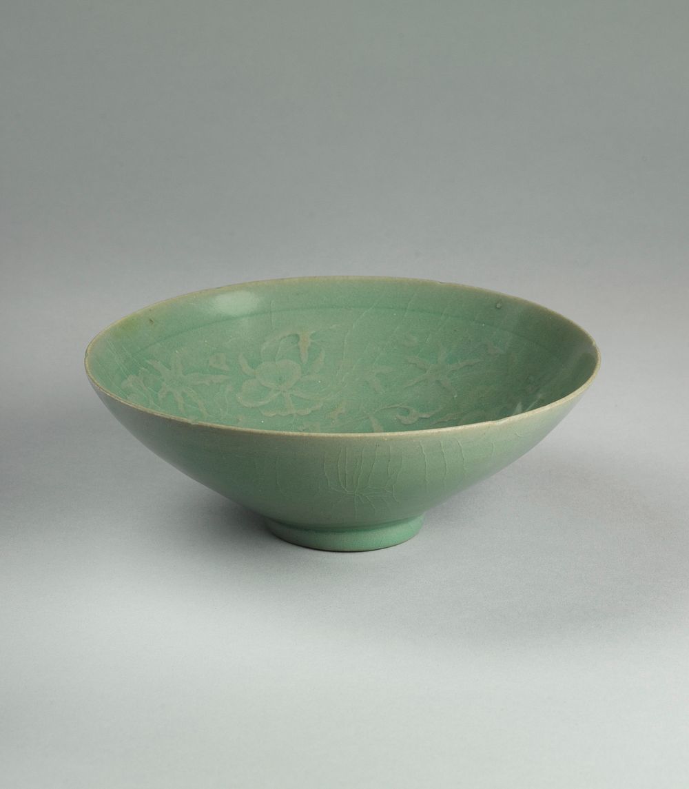 celadon colored bowl with floral motif embedded under glaze; small foot, wide mouth. Original from the Minneapolis Institute…