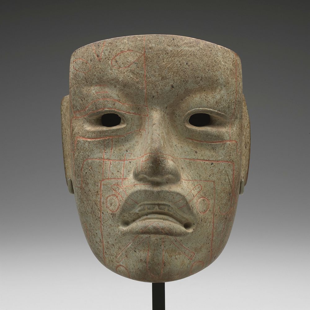 human face with long ears; open mouth with teeth; red linear designs. Original from the Minneapolis Institute of Art.
