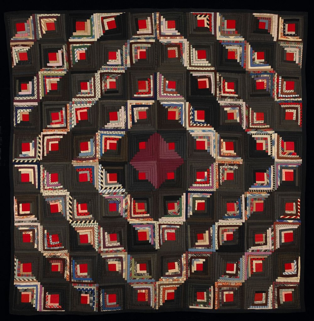 blocks arranged in Barn Raising pattern; block centers of red wool; strips in variety of solid colors and prints; blue edge…