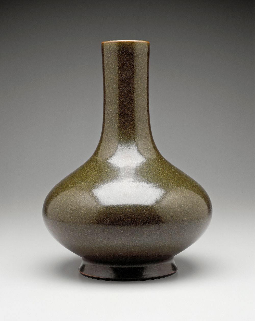 porcelain vase with compressed globular body; tall cylindrical neck; cha yeh-mo 'teadust' glaze. Original from the…
