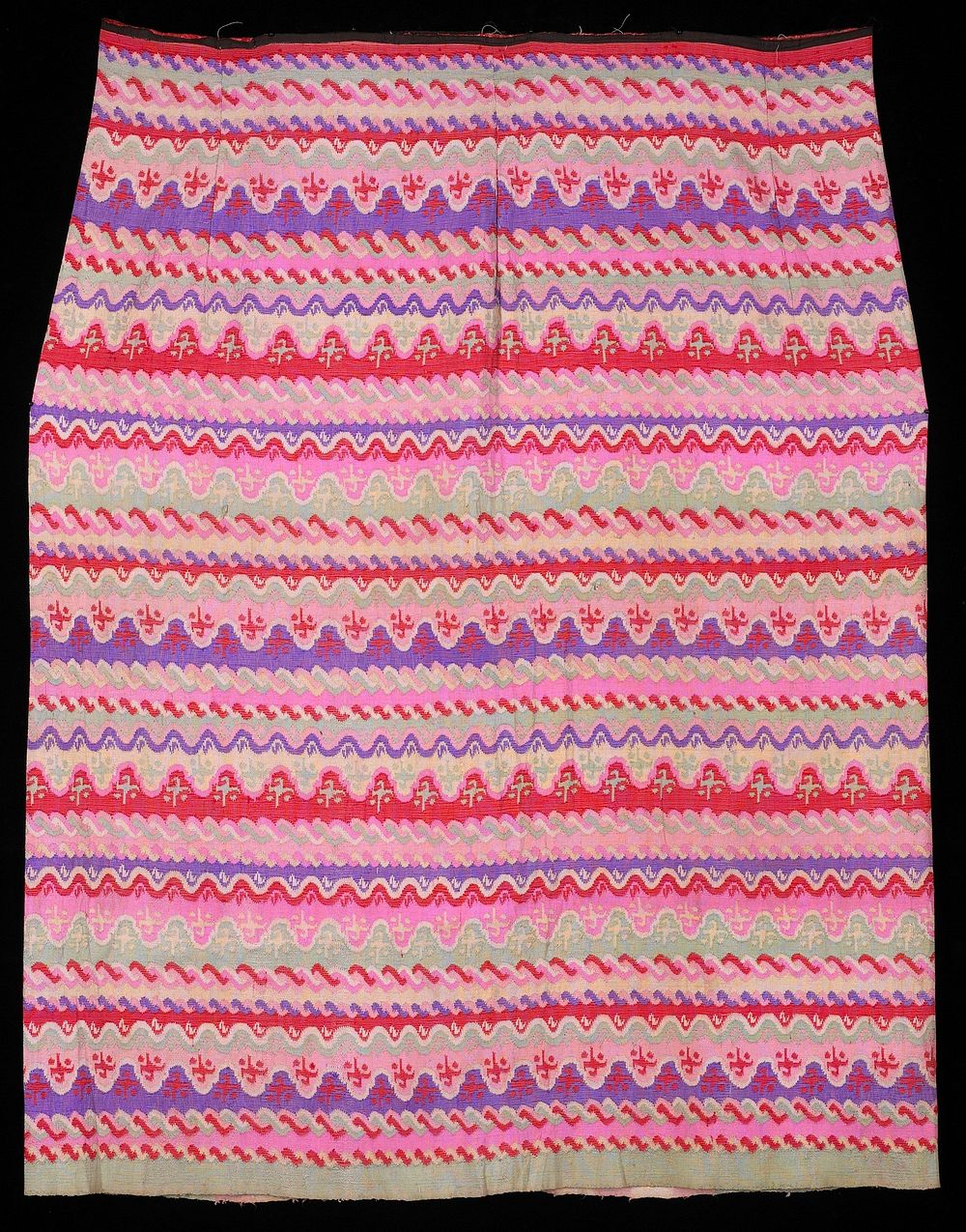 wavy horizontal designs in repetitive rows of purple, pink, Chinese red and green; 1/2" remnant of black cotton waistband;…