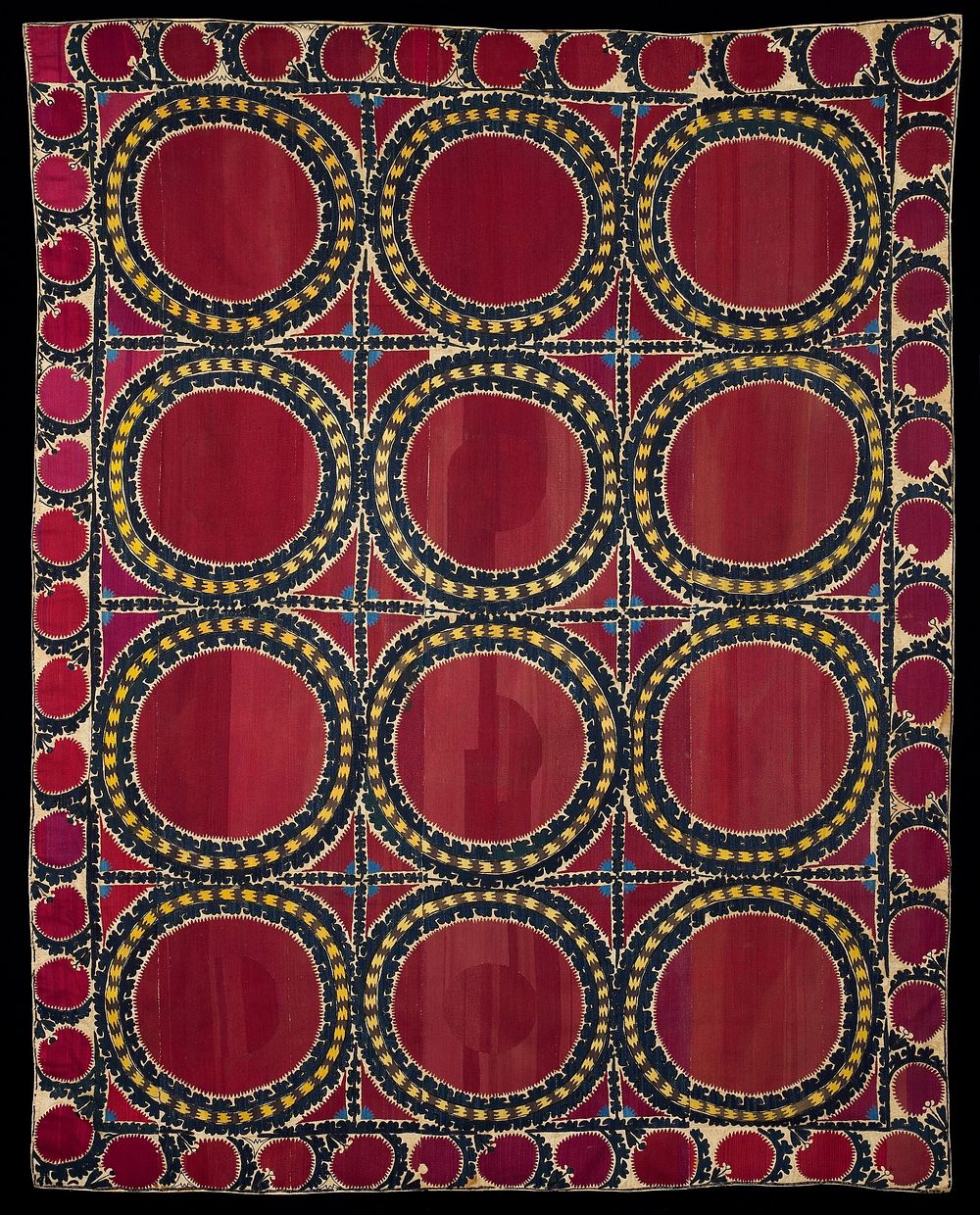 Newly lined. Silk embroidery on coarse tan cotton ground. Red dominates. Twelve large circles with 4: borders around…