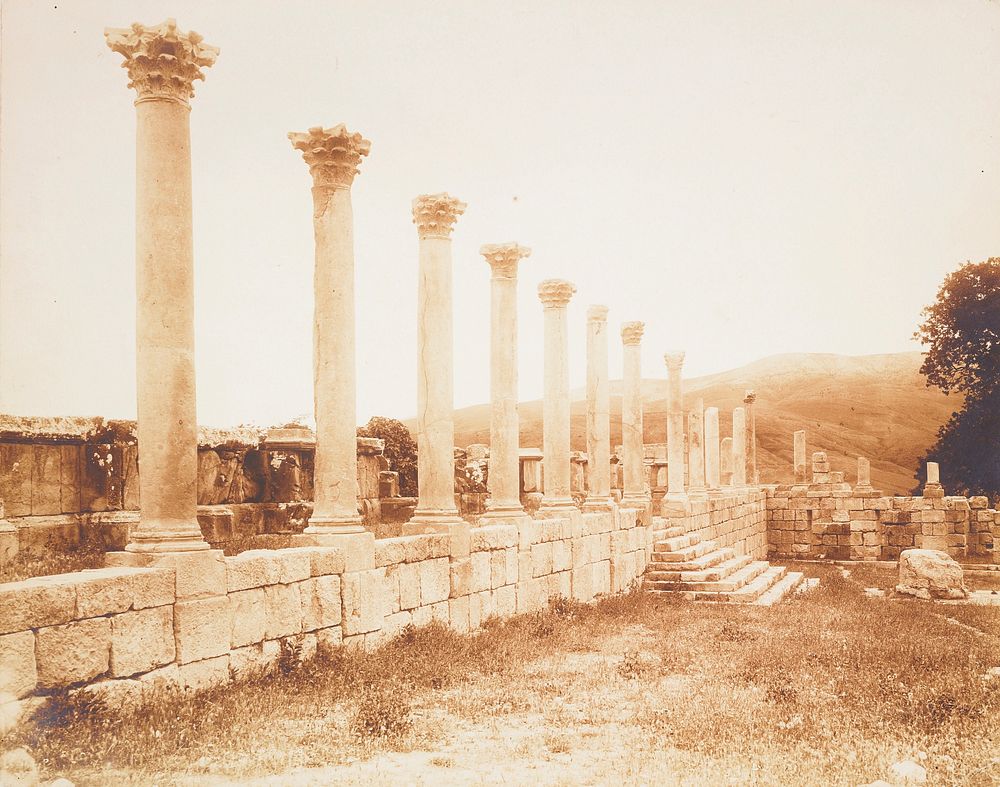 ruins with row of Corinthian columns on a stone wall; countryside in background. Original from the Minneapolis Institute of…