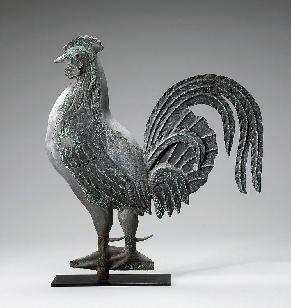 standing rooster; leaf-like delineated tail feathers; light-colored beak; green-black patina; stylized feet attached to…