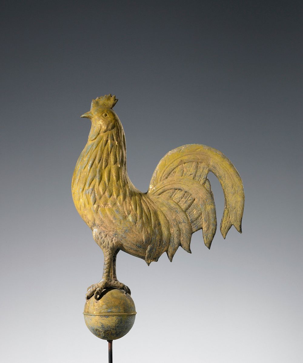 rooster standing on a ball with rib at center; gold patina. Original from the Minneapolis Institute of Art.