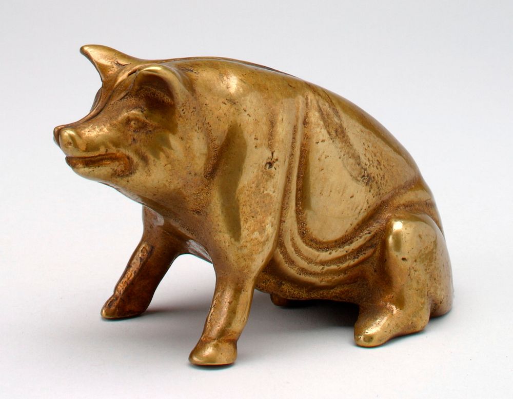 seated smiling brass pig; PR hip inside a raised circle is letter "V". Original from the Minneapolis Institute of Art.