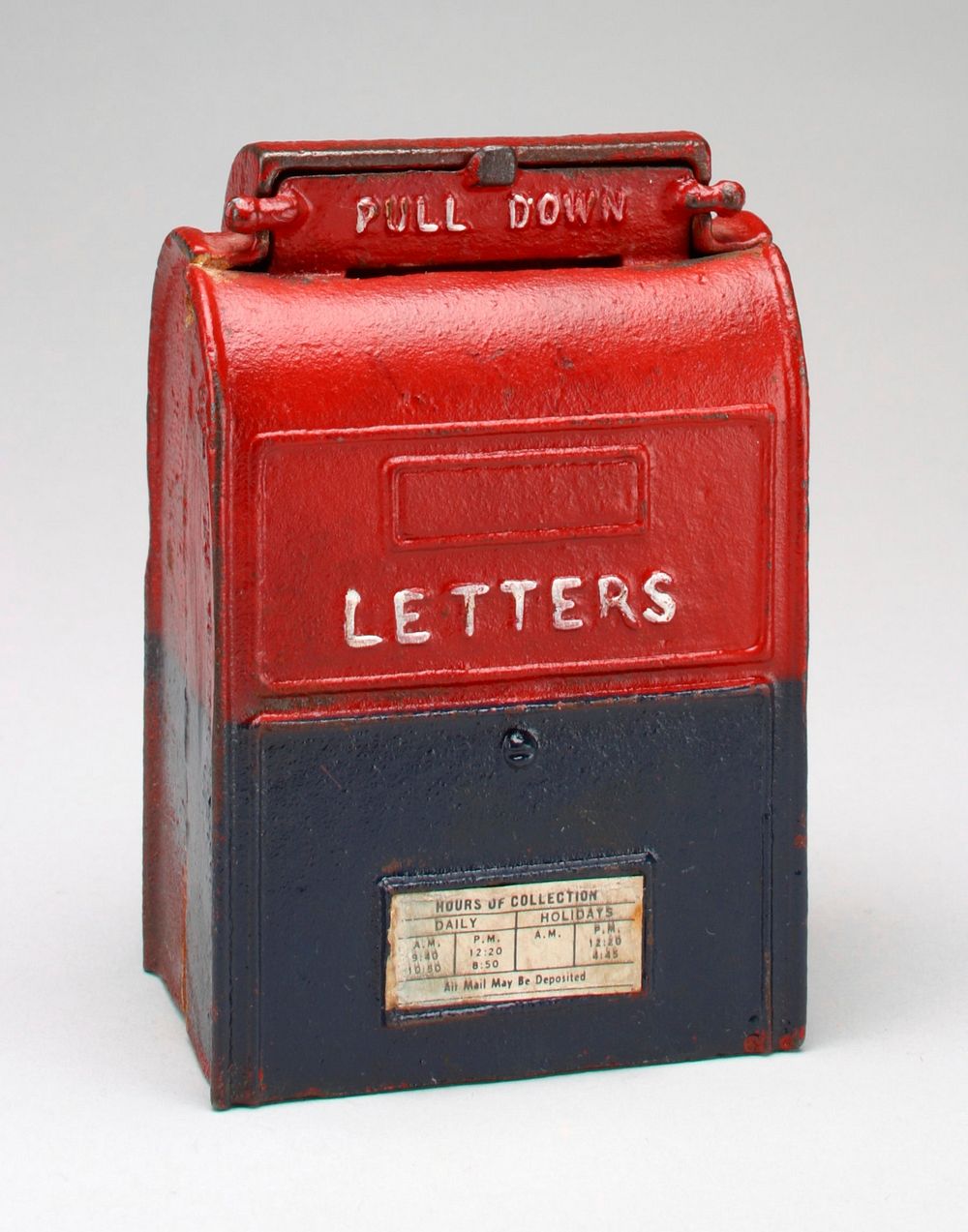 red and blue letterbox of metal with pull down mail slot at top and hours of collection on front. Original from the…