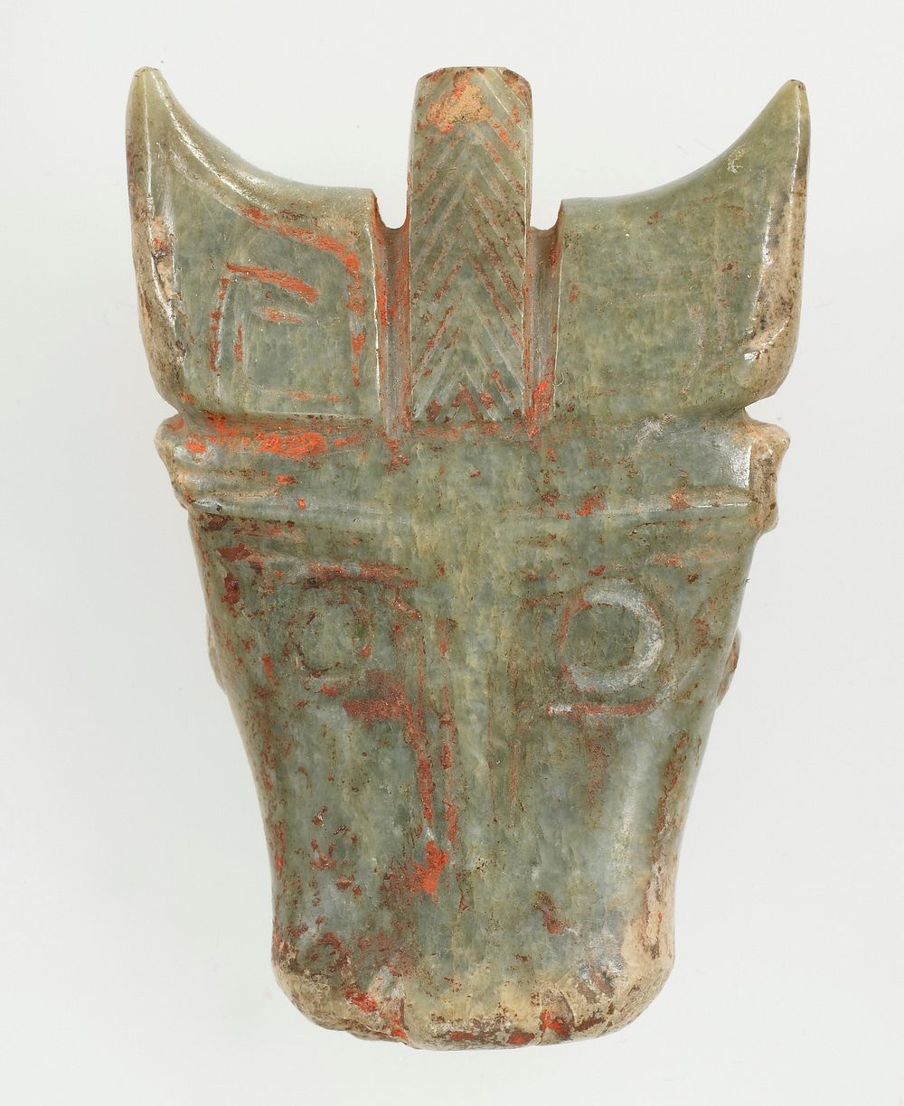 Mask of animal with horns can be identified as bull; simple incision to indicate the detail of the animal on the front only.…