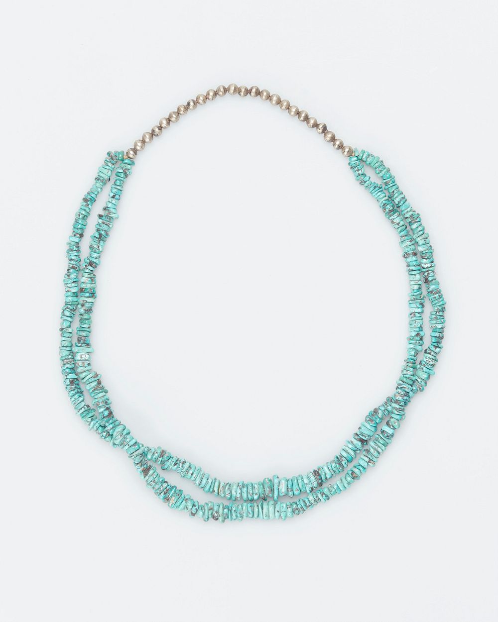 double strand of small turquoise nuggets and single row of silver beads at top. Original from the Minneapolis Institute of…