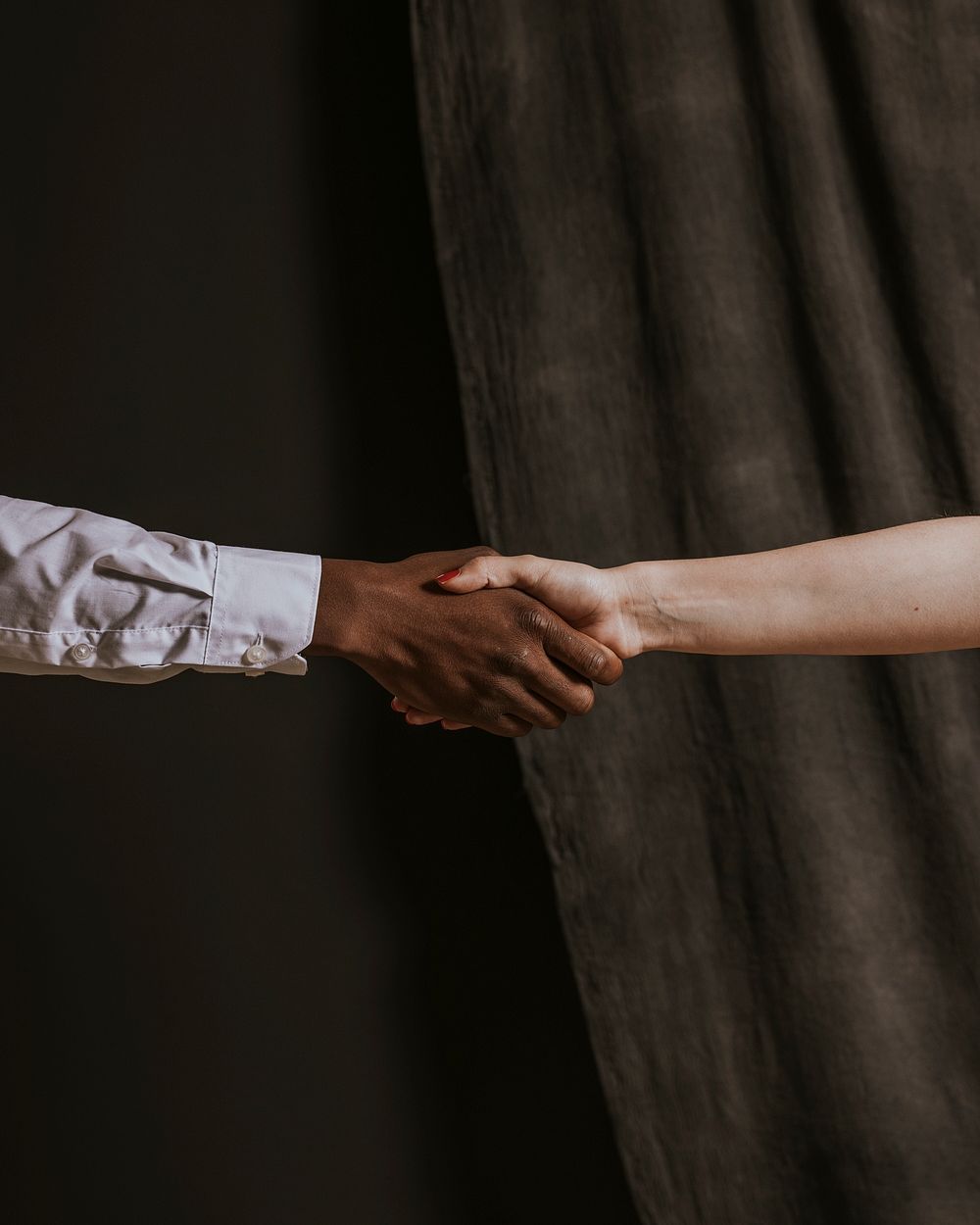 Diverse people shaking hands