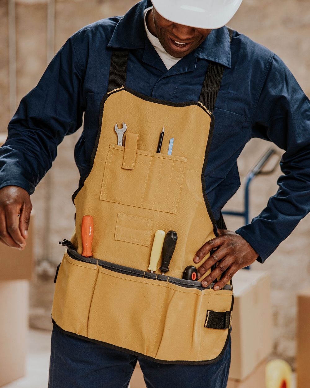 Construction worker wearing handyman apron with tools