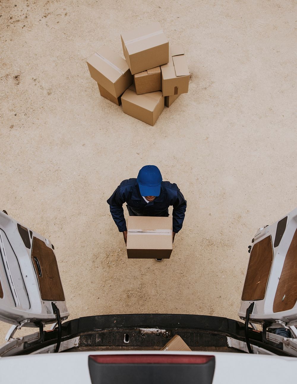 Removal service worker unloading box from the van