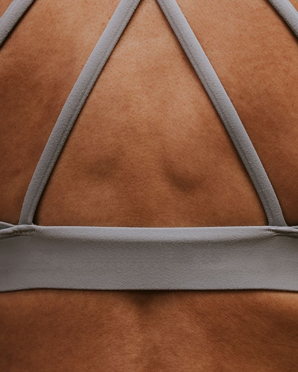 Woman wearing sports bra, closeup rear view photo