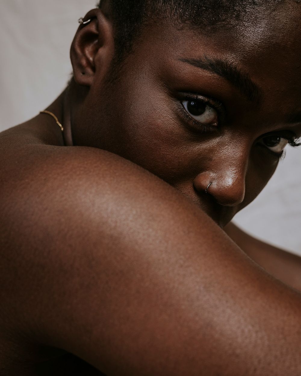 African woman looking over bare shoulder photo