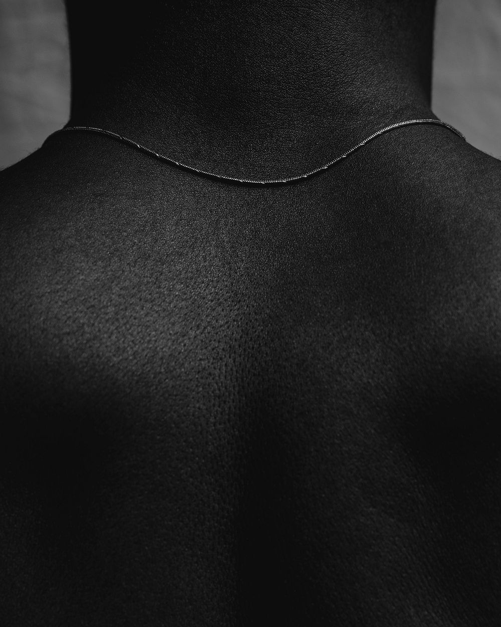 Closeup African woman's bare back, black and white photo