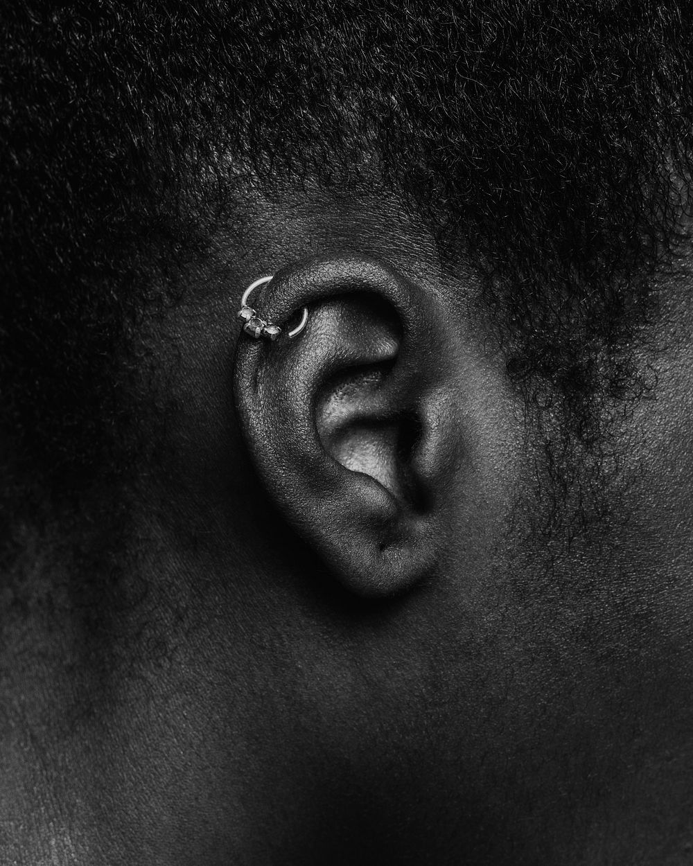 African woman wearing ear piercing, black and white photo