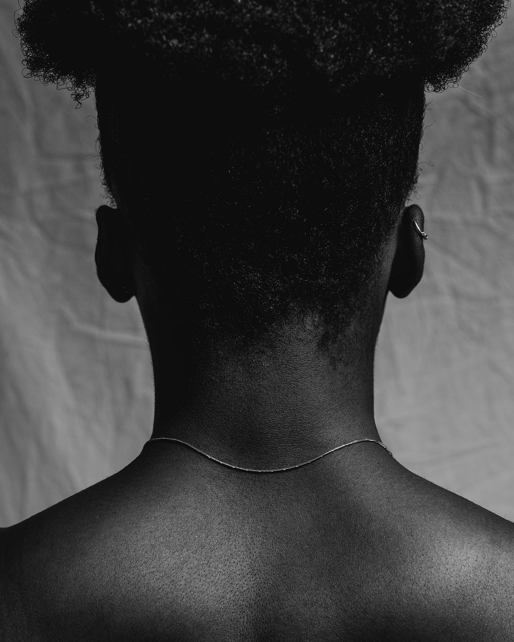 African woman's bare neck, rear view, black and white photo