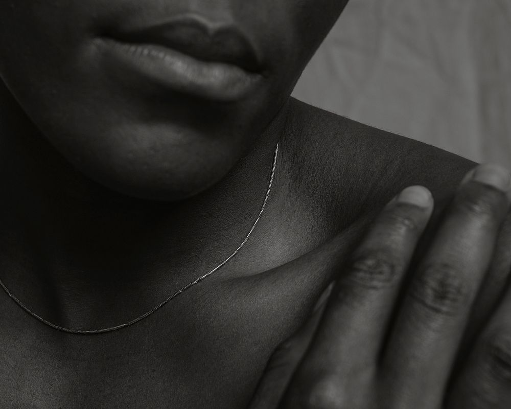 African woman, bare shoulders closeup, black and white photo