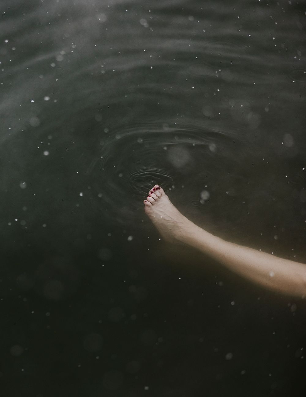 Travel aesthetic background, foot floating in water