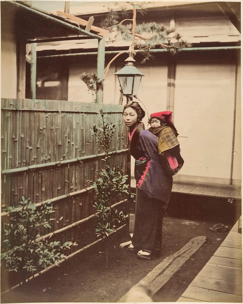 [Japanese Woman in Traditional Dress Posing with a Child on her Back]